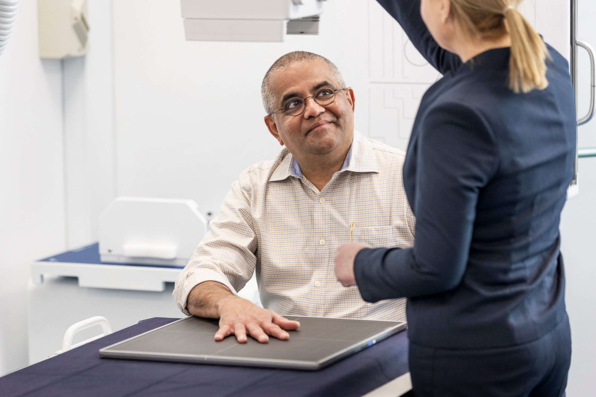 Nurse Doing a Hand X ray to a Man | Ultrasound Locations Near Me | Radiology Tasmania