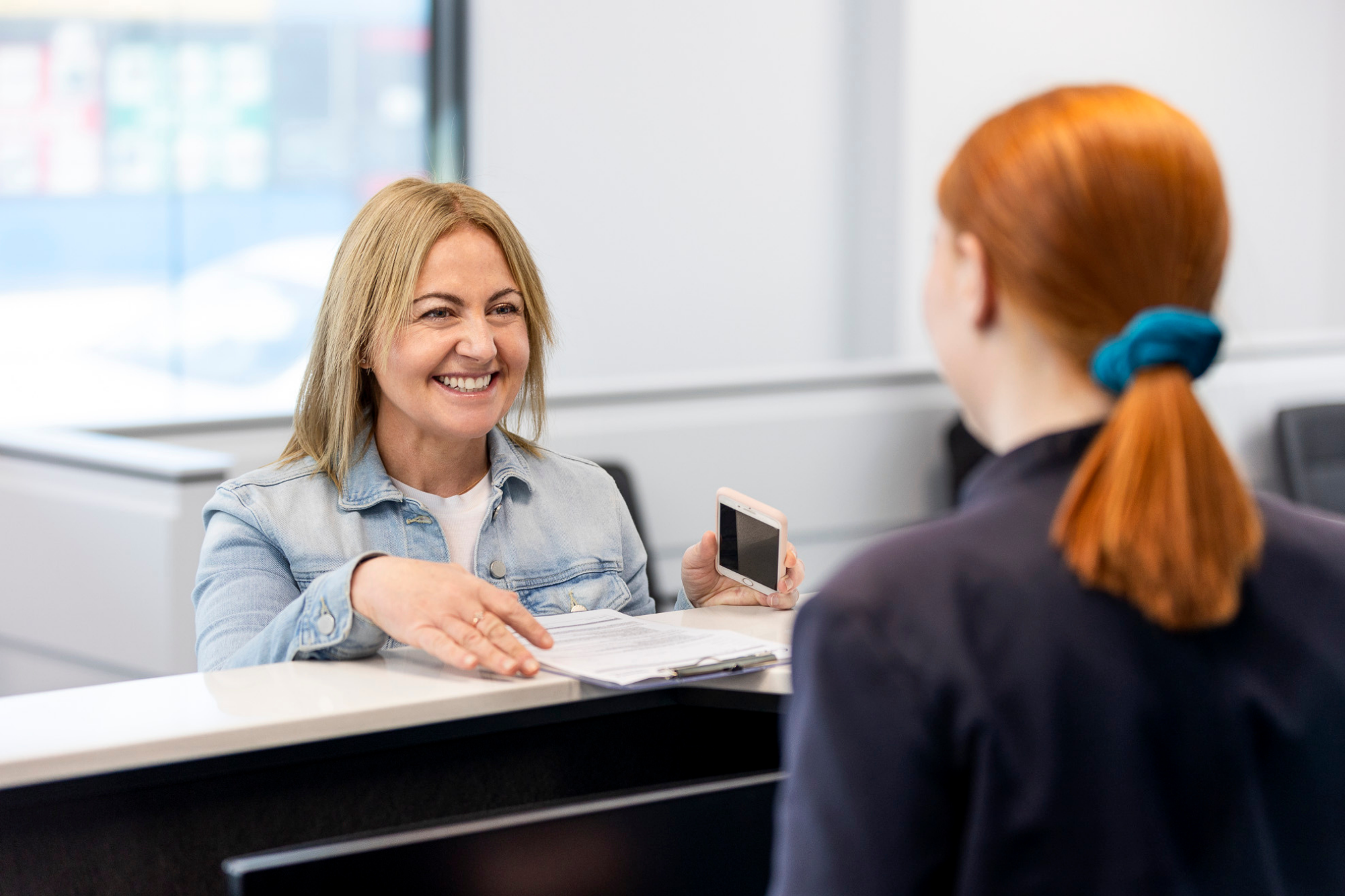 Woman Paying Fees & Bill at A Counter | Women's Imaging Clinic | Radiology Tasmania
